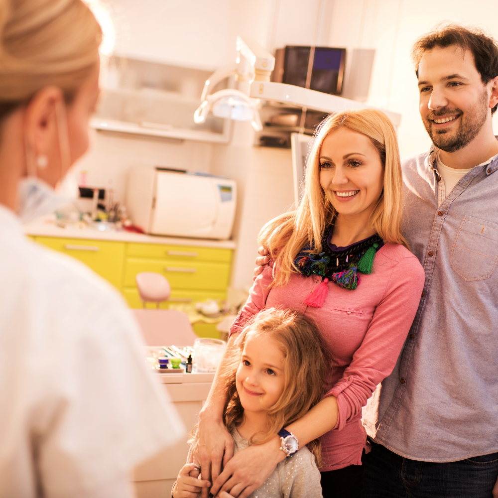 Family smiling at dentist office