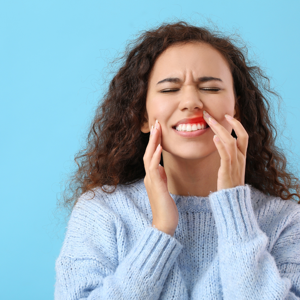 woman aching from gum pain.
